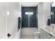 Stylish bathroom with blue hexagon tiles in shower, white cabinets and modern fixtures at 1405 Watts St, Durham, NC 27701