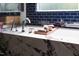 Marble-clad tub featuring chrome fixtures and a wood bath caddy at 1405 Watts St, Durham, NC 27701