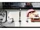 Close-up of a bathtub with marble accents and a wood bath caddy at 1405 Watts St, Durham, NC 27701