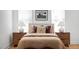 Comfortable bedroom with neutral decor, wooden nightstands, and soft bedding at 1405 Watts St, Durham, NC 27701