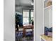 Dining room with wood floors, a large window, and a view from the hallway at 1405 Watts St, Durham, NC 27701