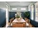 Elegant dining room with wainscoting, a large wooden table, and stylish chairs at 1405 Watts St, Durham, NC 27701