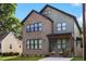 Beautiful two-story home with brick and siding, landscaped yard, and charming front porch at 1405 Watts St, Durham, NC 27701