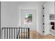 Hallway with black stair railing, wood floors, modern lighting and window view at 1405 Watts St, Durham, NC 27701