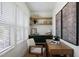Charming home office featuring a built-in desk, open shelving, and ample natural light at 1405 Watts St, Durham, NC 27701