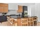 Spacious kitchen showcasing a large island with seating and modern stainless steel appliances at 1405 Watts St, Durham, NC 27701