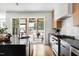 Modern kitchen with a large island, stainless steel appliances, and access to an outdoor patio at 1405 Watts St, Durham, NC 27701