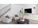 Bright living room with hardwood floors, a staircase, and comfortable seating at 1405 Watts St, Durham, NC 27701