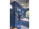 Stylish shower featuring a rainfall showerhead and blue subway tile at 1405 Watts St, Durham, NC 27701