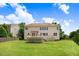 Spacious backyard featuring a wooden deck, well-maintained lawn, and partial fencing at 1420 Lagerfeld Way, Wake Forest, NC 27587