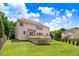 Large backyard with wooden deck, well-maintained lawn, and tree-lined perimeter at 1420 Lagerfeld Way, Wake Forest, NC 27587