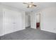 Neutral bedroom with ceiling fan, gray carpet and double doors at 1420 Lagerfeld Way, Wake Forest, NC 27587