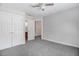 A well-lit bedroom featuring neutral walls and carpet, double closet, and ensuite bathroom at 1420 Lagerfeld Way, Wake Forest, NC 27587