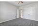 A bedroom with neutral walls and carpet, along with double doors, offering a serene and flexible space at 1420 Lagerfeld Way, Wake Forest, NC 27587