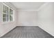 Bright bedroom with gray carpet, neutral walls, a large window, and crown molding at 1420 Lagerfeld Way, Wake Forest, NC 27587