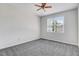 A bright bedroom with a ceiling fan and large window to provide plenty of natural light at 1420 Lagerfeld Way, Wake Forest, NC 27587