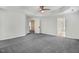 Spacious bedroom features a tray ceiling, neutral paint, carpeted floor, and multiple entry doors at 1420 Lagerfeld Way, Wake Forest, NC 27587