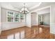 Dining room boasts hardwood floors, white trim, chandelier, and abundant natural light at 1420 Lagerfeld Way, Wake Forest, NC 27587
