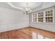 Dining room with hardwood floors, white trim, and modern chandelier at 1420 Lagerfeld Way, Wake Forest, NC 27587