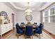 Formal dining room featuring hardwood floors, modern chandelier, and seating for six at 1420 Lagerfeld Way, Wake Forest, NC 27587