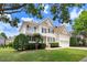 View of a charming two-story home with beautiful landscaping, front porch, and attached two-car garage at 1420 Lagerfeld Way, Wake Forest, NC 27587