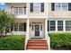 Inviting front entrance with brick steps, white railings, and well-maintained landscaping at 1420 Lagerfeld Way, Wake Forest, NC 27587