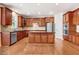 Spacious kitchen features wood cabinets, stainless steel appliances, and a center island with a granite countertop at 1420 Lagerfeld Way, Wake Forest, NC 27587