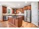 Spacious kitchen features wood cabinets, stainless steel appliances, and a center island with a granite countertop at 1420 Lagerfeld Way, Wake Forest, NC 27587