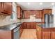 Spacious kitchen features wood cabinets, stainless steel appliances, and a center island with a granite countertop at 1420 Lagerfeld Way, Wake Forest, NC 27587