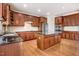 Spacious kitchen features wood cabinets, stainless steel appliances, and a center island with a granite countertop at 1420 Lagerfeld Way, Wake Forest, NC 27587