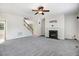 Cozy living room boasts neutral paint, carpet, fireplace, and a staircase at 1420 Lagerfeld Way, Wake Forest, NC 27587