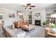Comfortable living room featuring a fireplace, staircase, and stylish furnishings at 1420 Lagerfeld Way, Wake Forest, NC 27587