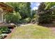 Lush backyard featuring grassy area, garden, wood stairway, and an inviting outdoor space at 1503 Hollywood St, Durham, NC 27701