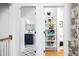View from the hallway of a modern bathroom and a storage closet with organized shelves at 1503 Hollywood St, Durham, NC 27701