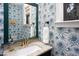 Stylish powder room featuring floral wallpaper, granite counters, and bronze fixtures at 1503 Hollywood St, Durham, NC 27701