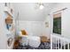 Bright Bedroom with a comfortable armchair, bookshelves, and a window to provide natural light at 1503 Hollywood St, Durham, NC 27701