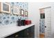 Butler pantry with elegant floral wallpaper and countertops with modern appliances at 1503 Hollywood St, Durham, NC 27701