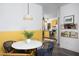 Dining area with bright light fixture and views of kitchen with granite countertops at 1503 Hollywood St, Durham, NC 27701