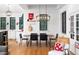 Eat-in dining area featuring modern chandelier, black framed windows, and wood dining table at 1503 Hollywood St, Durham, NC 27701