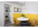 Dining area with rattan chairs and views of in unit laundry and white marble table at 1503 Hollywood St, Durham, NC 27701