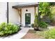 Charming front entrance featuring a green door, white siding, and manicured landscaping at 1503 Hollywood St, Durham, NC 27701