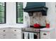 Well-appointed kitchen with a modern range hood, stainless steel appliances, and white countertops at 1503 Hollywood St, Durham, NC 27701
