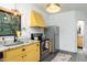 View of the kitchen with granite countertops, stainless steel appliances, and bright yellow cabinets at 1503 Hollywood St, Durham, NC 27701