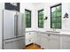 Bright kitchen showcasing stainless steel refrigerator, white cabinetry, and stylish countertops, perfect for culinary enthusiasts at 1503 Hollywood St, Durham, NC 27701