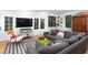 Comfortable living room with a gray sectional, patterned rug, and ample seating at 1503 Hollywood St, Durham, NC 27701