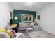 Comfortable living space featuring a gray sofa, stylish decor, and a well-lit desk area at 1503 Hollywood St, Durham, NC 27701
