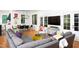 Bright and open living space featuring a large gray sofa and view of dining area and kitchen at 1503 Hollywood St, Durham, NC 27701
