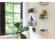 Bright room with a large window and stylish decorations like books and plants at 1503 Hollywood St, Durham, NC 27701