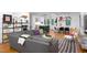 Open-concept living room with a gray sectional sofa, kitchen and dining area at 1503 Hollywood St, Durham, NC 27701