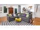 Cozy living room with a gray sectional sofa, patterned rug, and stylish decor at 1503 Hollywood St, Durham, NC 27701